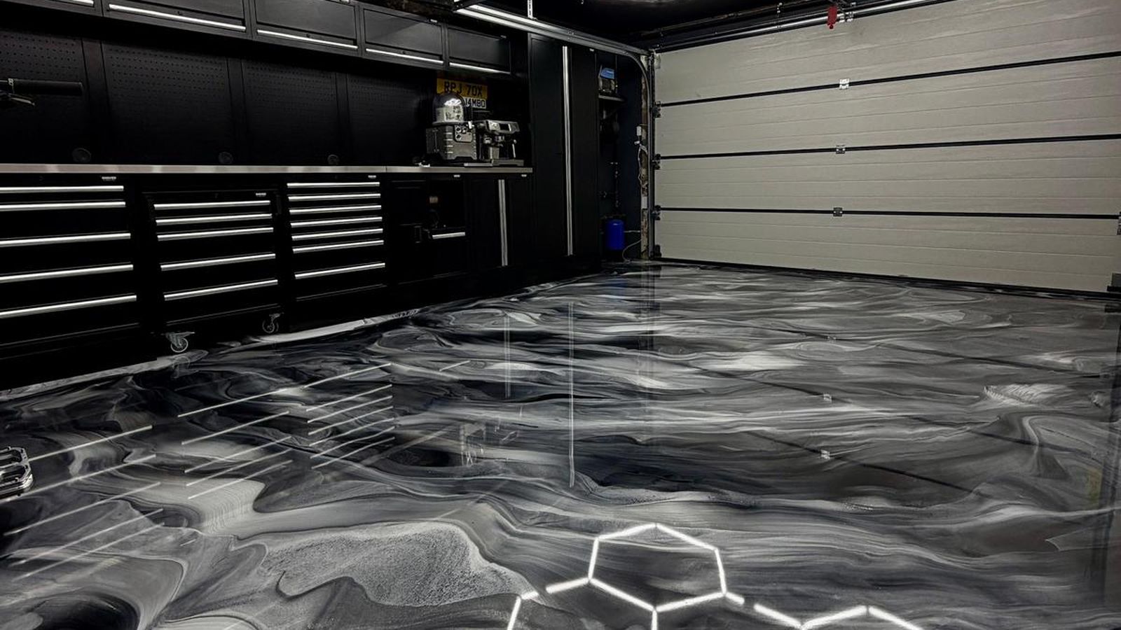 Black metallic epoxy resin floor under hexagon lighting