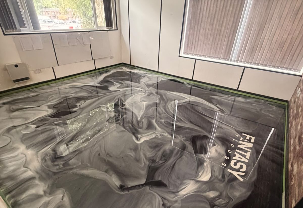 Black metallic commercial resin floor in an office after installation