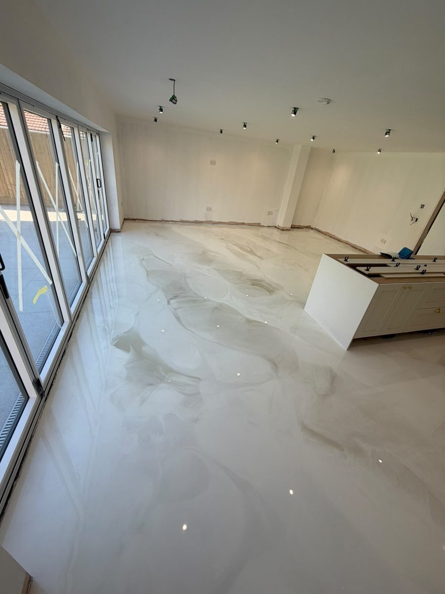 Pearl marble-effect poured resin floor in a bright open-plan living space