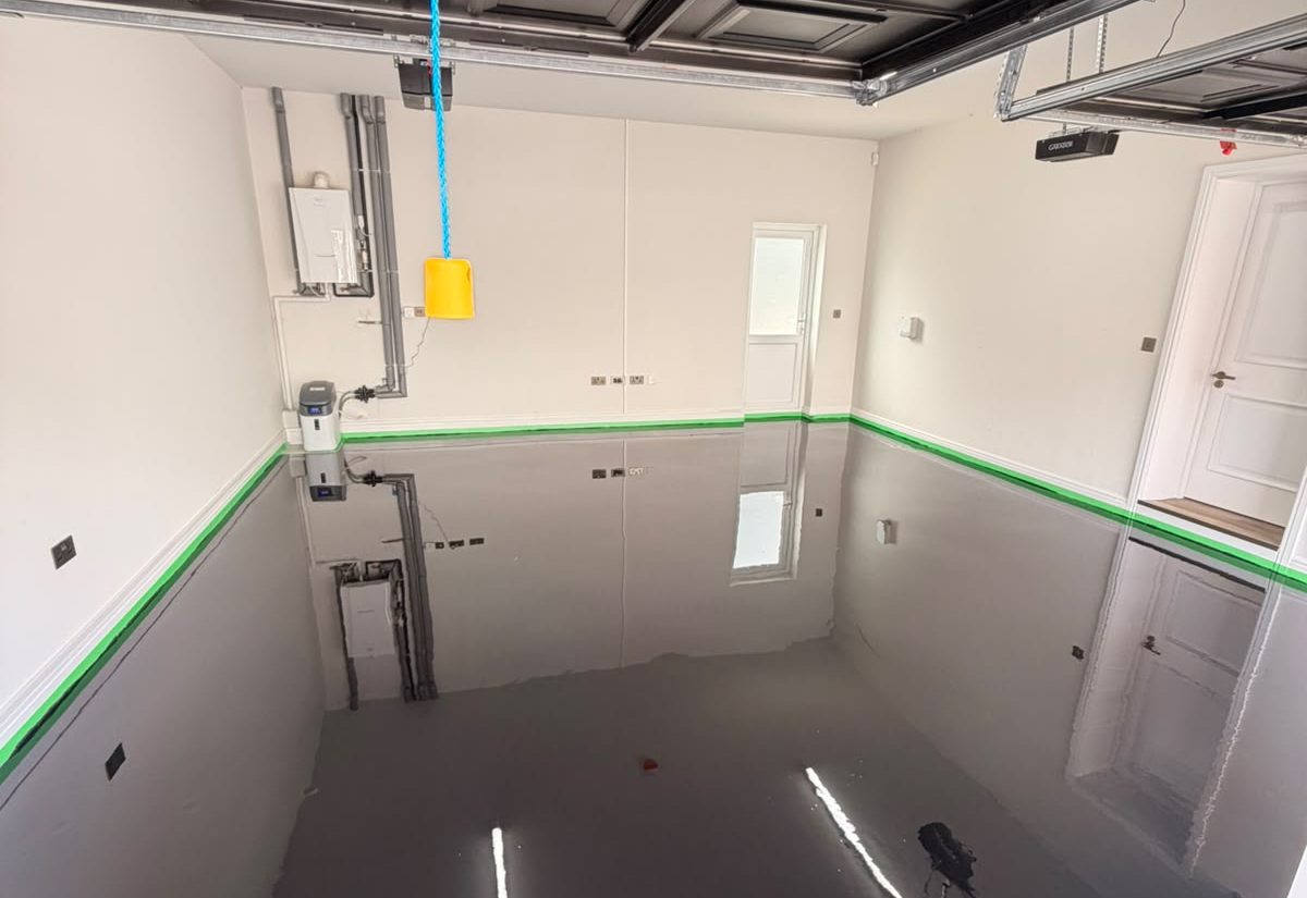 Garage before resin floor coating, bare primed concrete